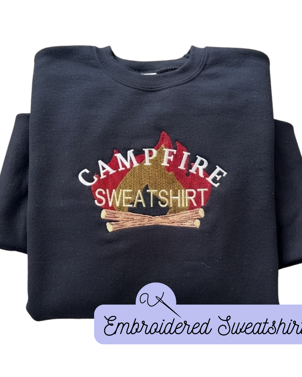 A folded black crewneck sweatshirt with an embroidered campfire graphic on the chest. The graphic features the words 'CAMPFIRE' in white arched lettering over a red campfire pit, with 'SWEATSHIRT' in tan lettering and two small wooden logs.